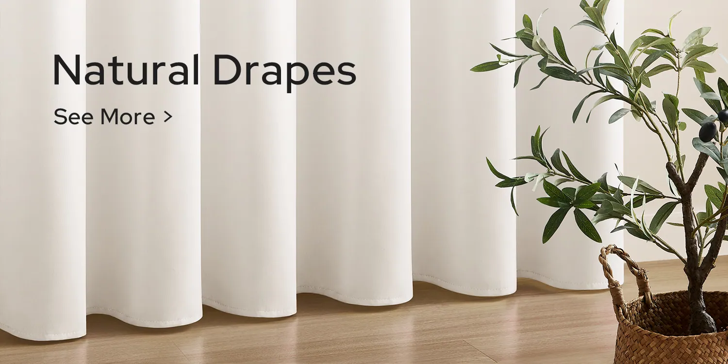 Natural drapes hanging full length beside a potted olive tree