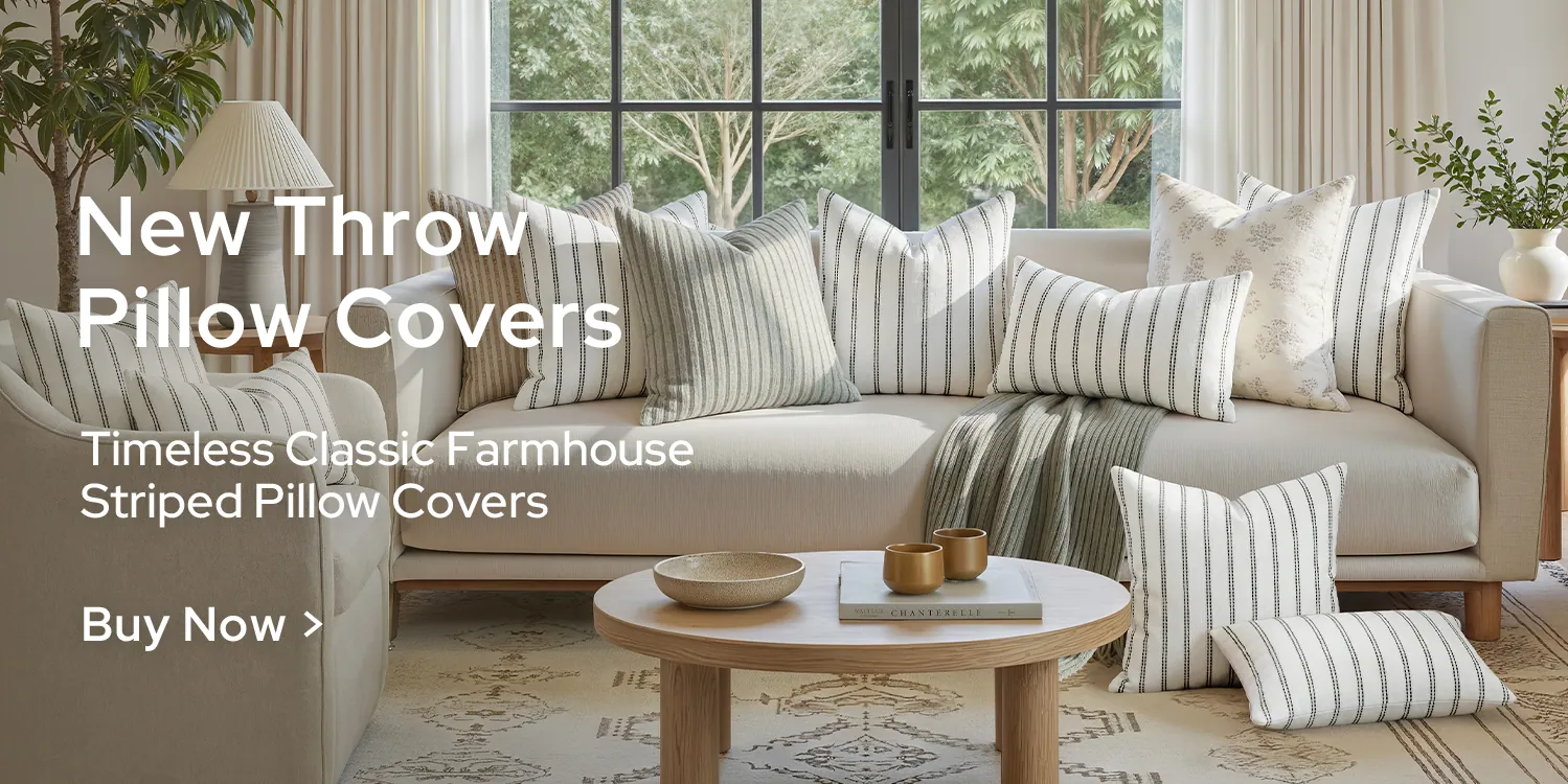 Striped pillow covers on a pale sofa in a farmhouse living room
